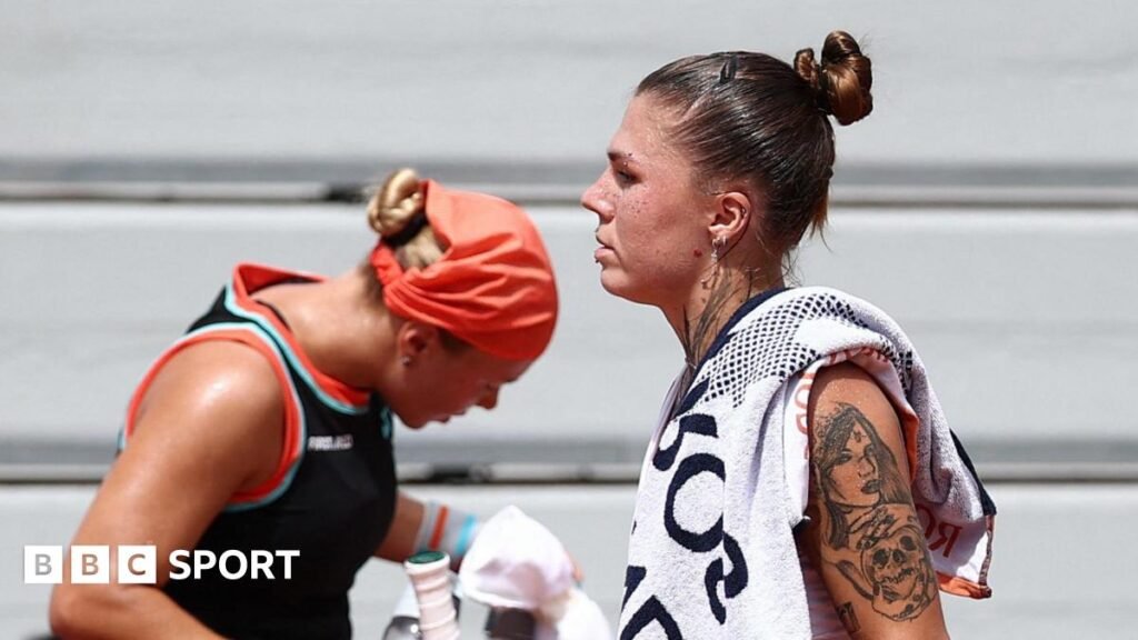Diana Shnaider and Oleksandra Oliynykova at a change of ends during their 2026 French Open match
