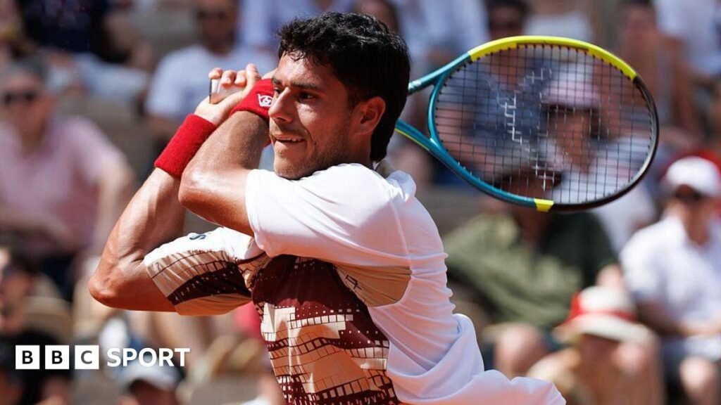 French Open 2026 results: Adolfo Daniel Vallejo criticised for questioning ‘courage’ of female umpire Adolfo Daniel Vallejo, wearing a white patterned t-shirt, plays a backhand with his yellow, blue and black racquet held in two hands over his right shoulder