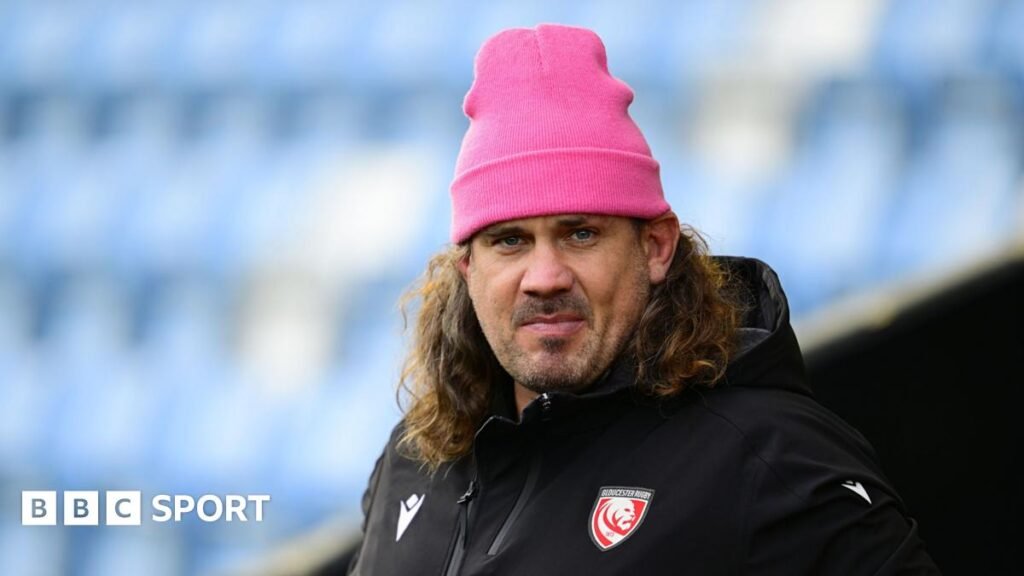 Gloucester-Hartpury: Head coach Dan Murphy pragmatic over player exits Gloucester-Hartpury head coach Dan Murphy, who has long, wavy, shoulder-length light brown hair, wearing a black jacket with the Gloucester-Hartpury logo on and a pink woolly hat.