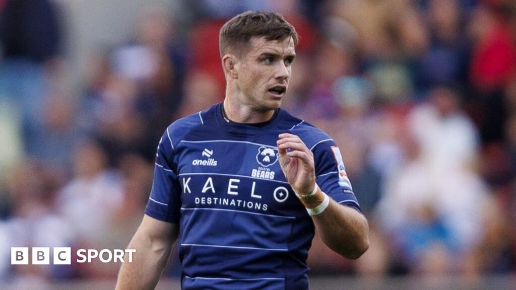 Prem team news: AJ MacGinty returns for Bristol-Bath derby Bristol Bears rugby player AJ MacGinty wearing a dark blue rugby shirt during a Premiership match with Leicester Tigers.