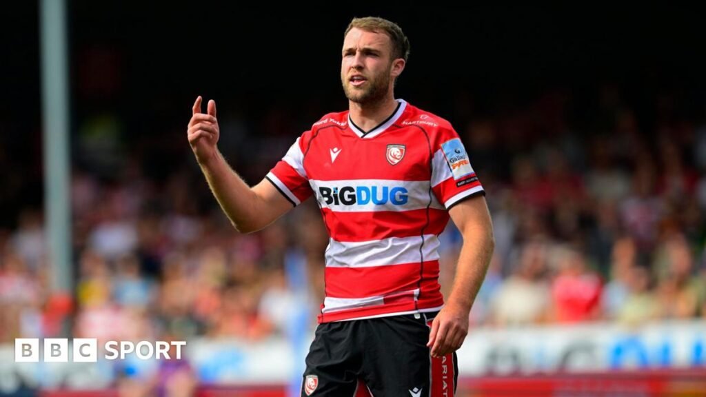 Gloucester Rugby player Max Llewellyn wearing his side's red and white home shirt during a Premiership Rugby game.