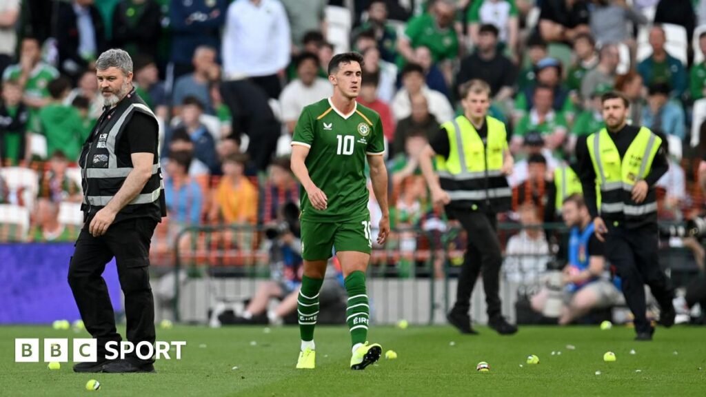 Republic of Ireland v Israel: Jamie McGrath expects controversy to ‘heat up’ after Qatar game disrupted Jamie McGrath walks between tennis balls during the protest