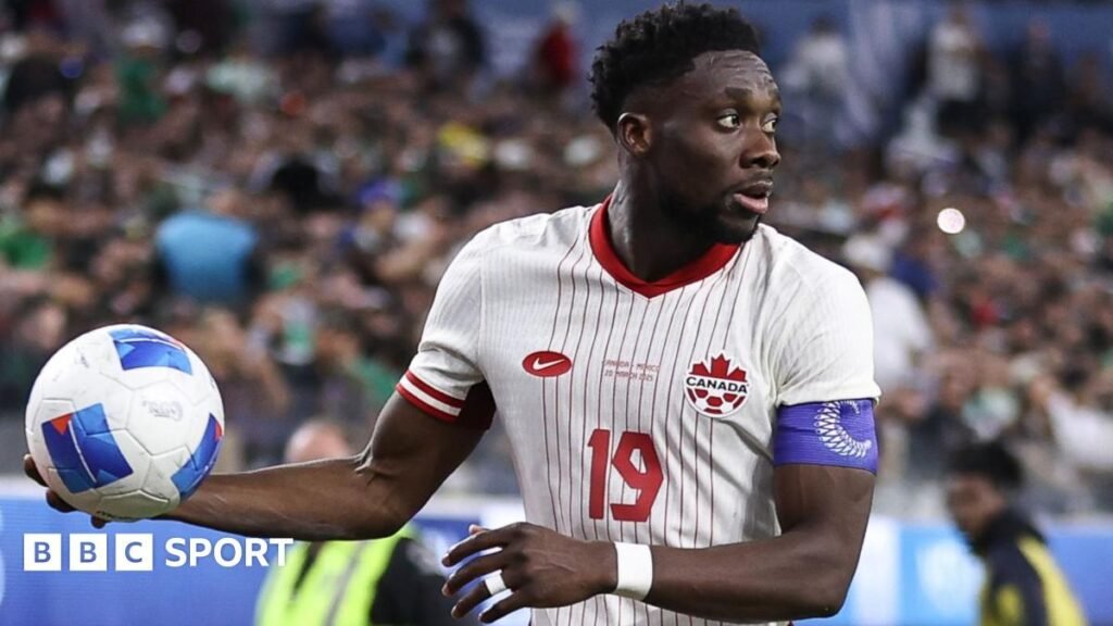 World Cup 2026: Bayern Munich’s Alphonso Davies to miss Canada’s tournament opener Alphonso Davies of Canada, in the team's largely white kit with red detail, holds a football in his right hand before taking a throw-in