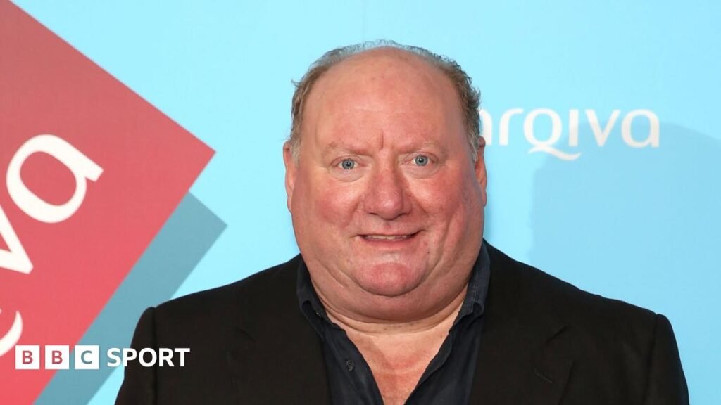 A picture of Alan Brazil wearing a blazer and shirt.