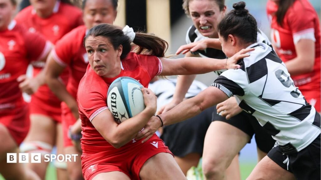 Kayleigh Powell of Wales fends off a Barbarians player