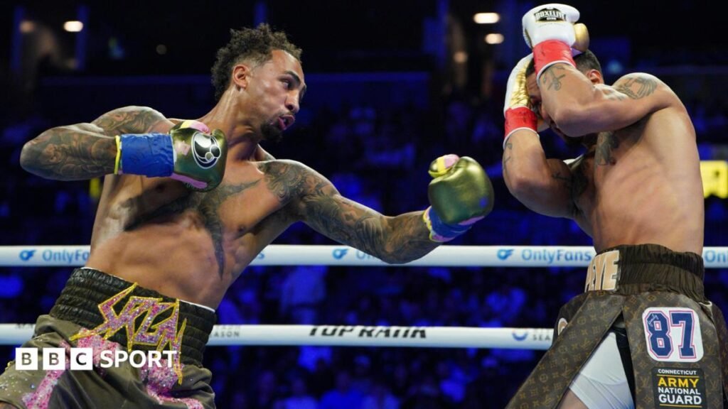 Great Britain's Ben Whittaker punches Richard Rivera during their light-heavyweight bout in Brooklyn
