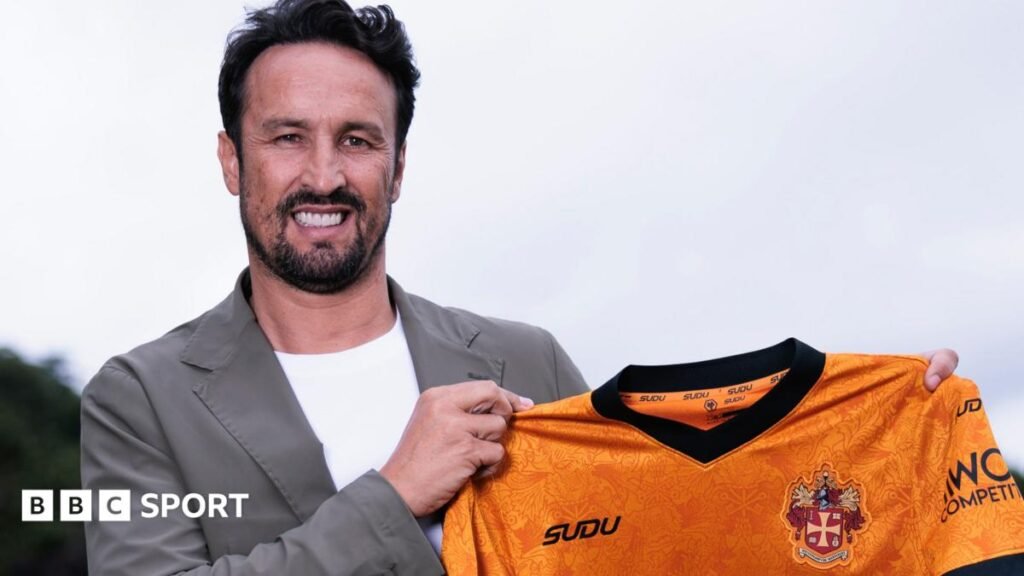 Cesar Peixoto: Portuguese named as new Wolverhampton Wanderers boss Cesar Peixoto holding a Wolves shirt while smiling