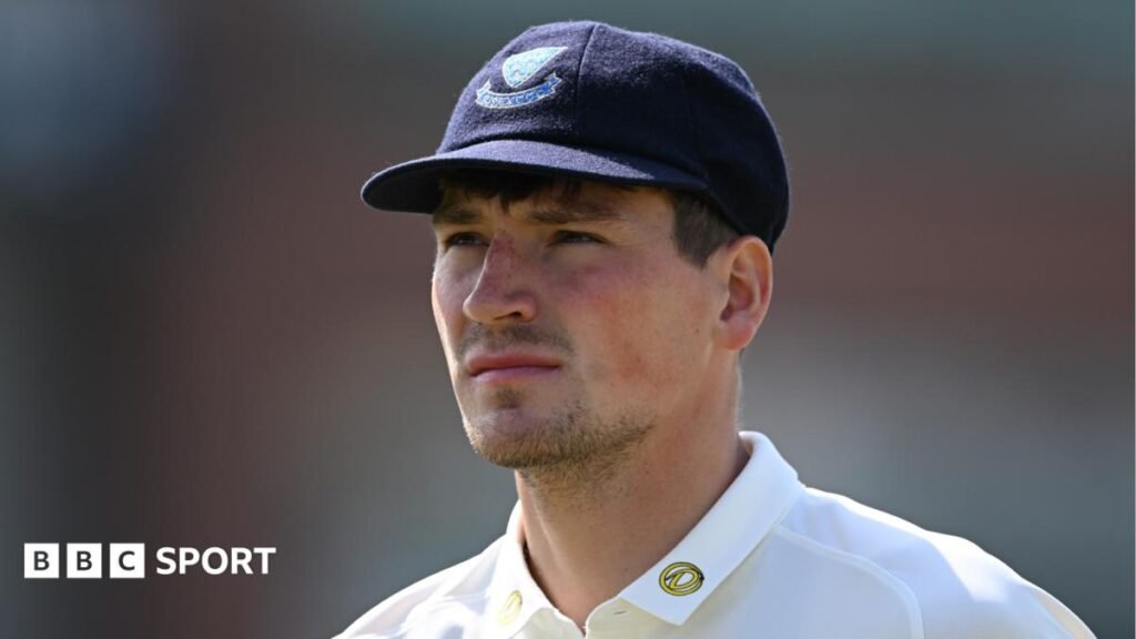 England call up Henry Crocombe for second Test as cover for Ollie Robinson Henry Crocombe looks on, while wearing a blue cap