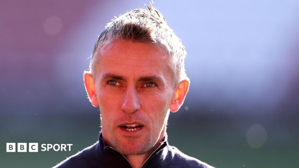 Ipswich Town: Manager Kieran McKenna resigns after promotion to Premier League Kieran McKenna head and shoulders picture, as he wears a zip-up top