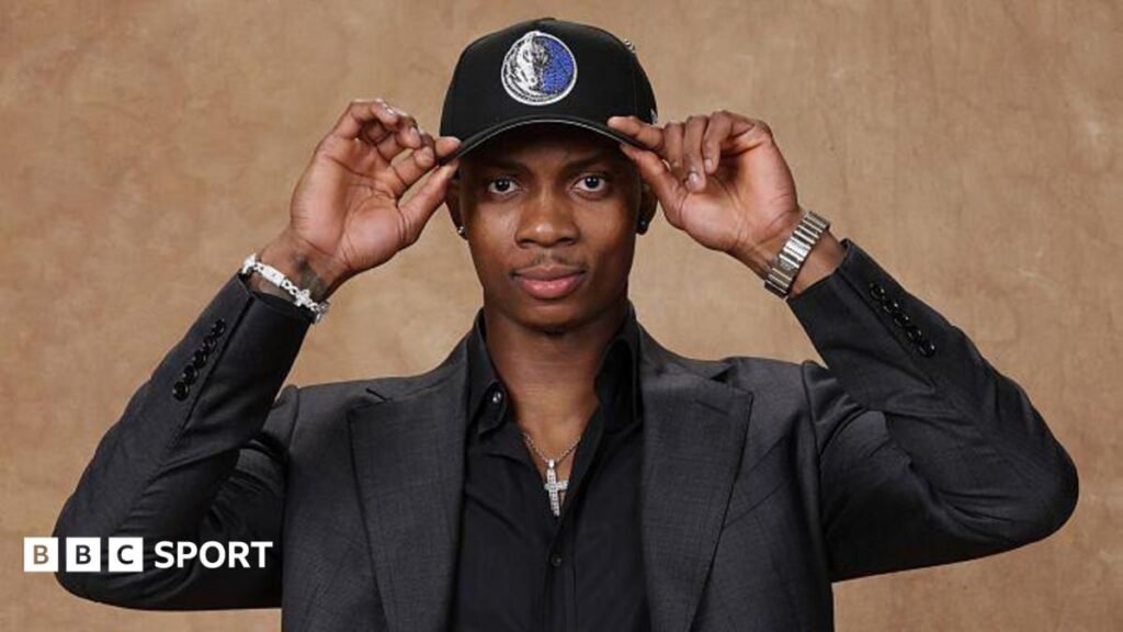 Tobi Lawal poses for a photo after being selected in the 2026 NBA Draft