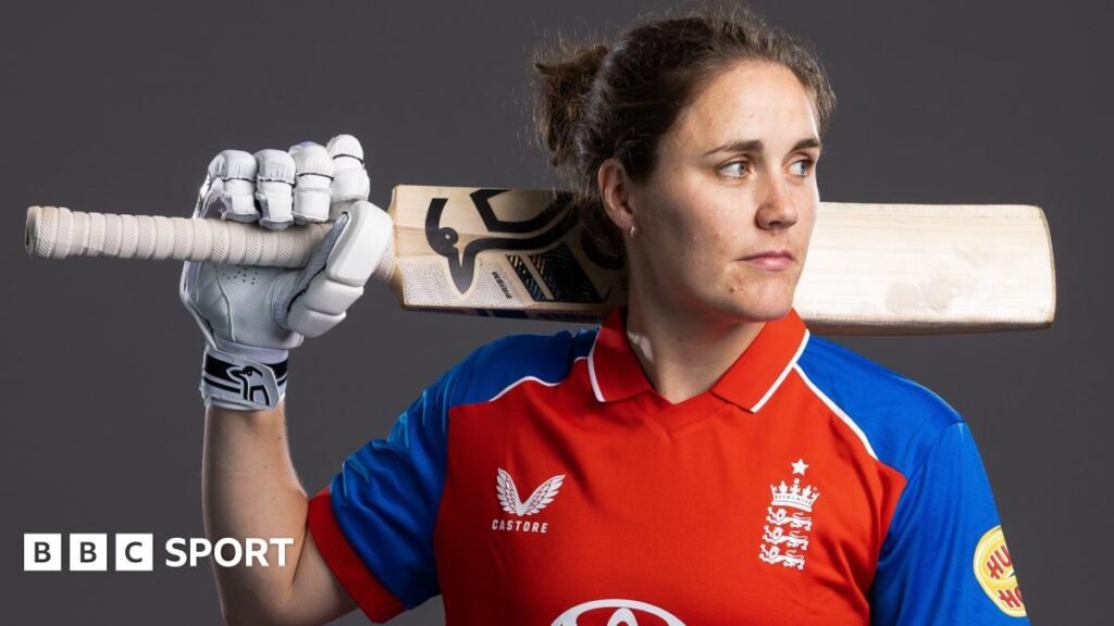 Nat Sciver-Brunt looks to the side while holding a bat in a photo shoot