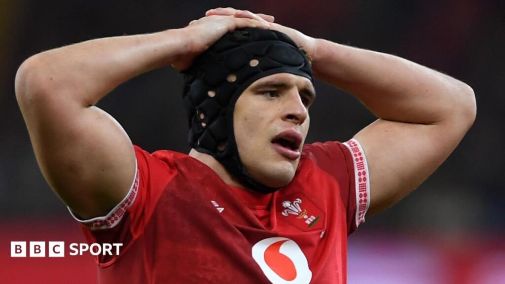 Dafydd Jenkins in action for Wales with his hands on his head