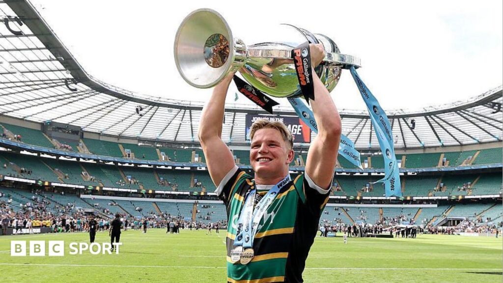 Northampton Saints: Can Prem Rugby champions become one of English rugby’s greats? Northampton flanker Henry Pollock, wearing the club's yellow, green and black shirt, lifts the Prem Rugby trophy above his head