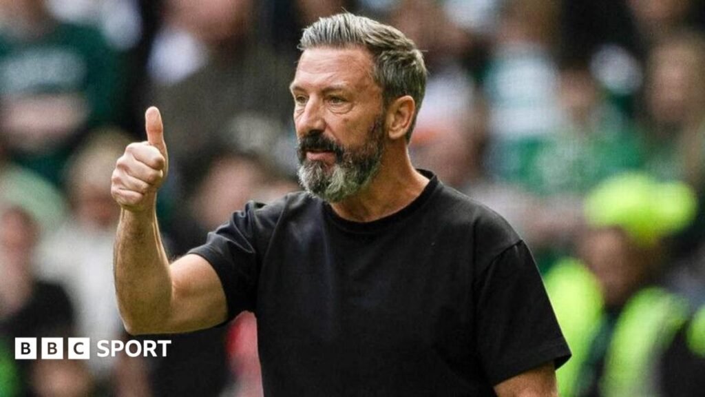 Hearts head coach Derek McInnes gives a thumbs up while standing on the touchline