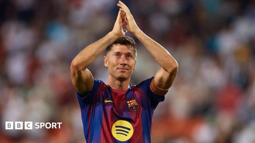 Robert Lewandowski applauds the Barcelona crowd at the end of his last game