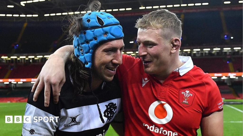 Wales' Leigh Halfpenny and Barbarians' Alun Wyn Jones embrace in Cardiff