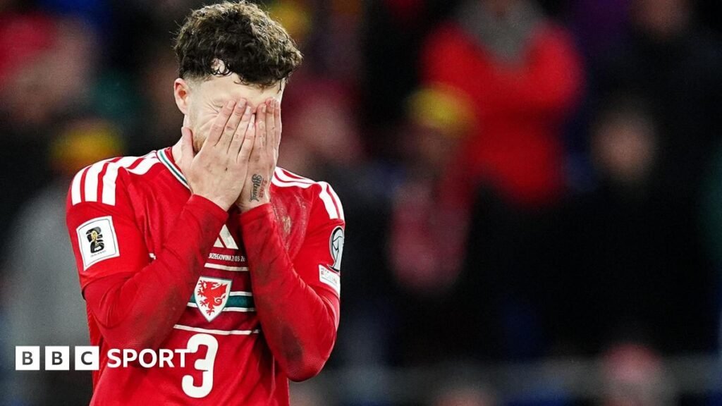 Wales' Neco Williams covers his face with his hands after missing his penalty in the shoot-out during the 2026 FIFA World Cup European Play-off Semi-final.