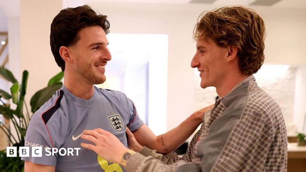 Anthony Gordon greets England team-mate Declan Rice as he arrives in Florida before the 2026 World Cup