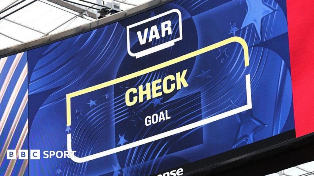 World Cup 2026: Is VAR being used differently to the Premier League? The big screen displays the VAR review after Iran's goal during the FIFA World Cup 2026 Group G match between Belgium and IR Iran at Los Angeles Stadium on June 21, 2026 in Inglewood, California.
