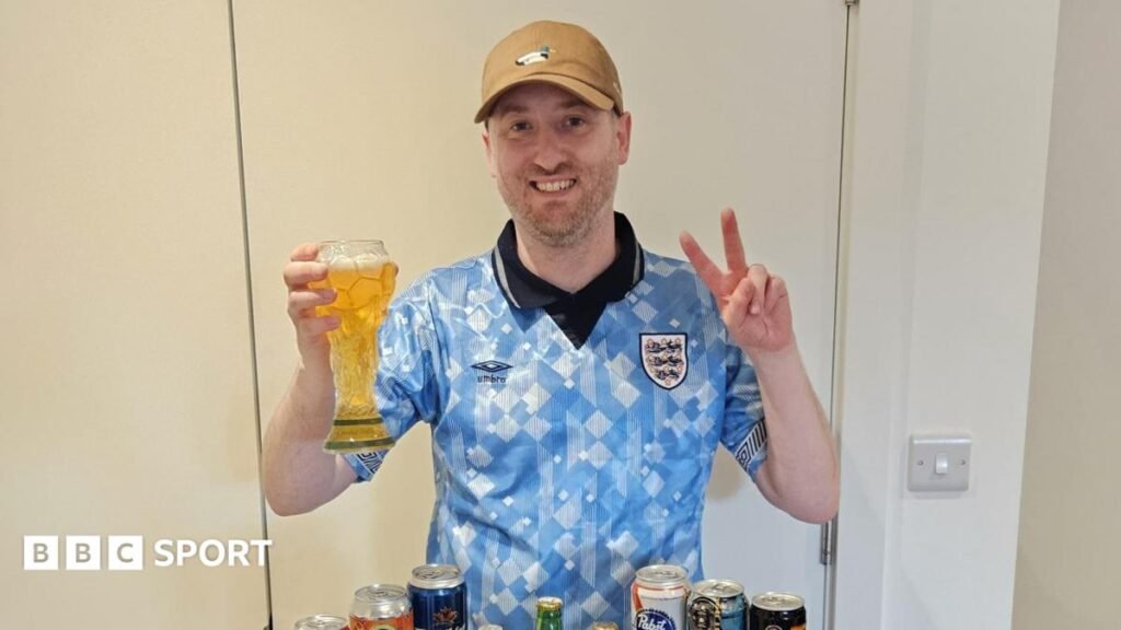 World Cup 2026: Meet the England fan who collected a beer from every nation Gus Hully holds a beer in a glass shaped like the World Cup trophy, while he wears a vintage light blue England shirt and a brown baseball cap
