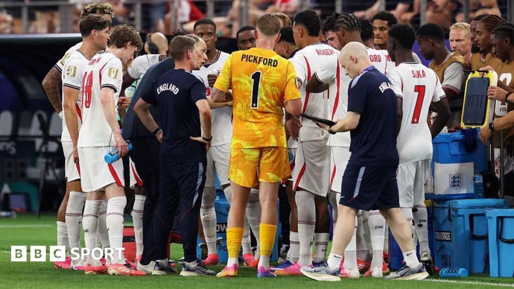 England players gather on the touchline for a hydration break during the 4-2 victory over Croatia at the 2026 FIFA World Cup in  Dallas, Texas