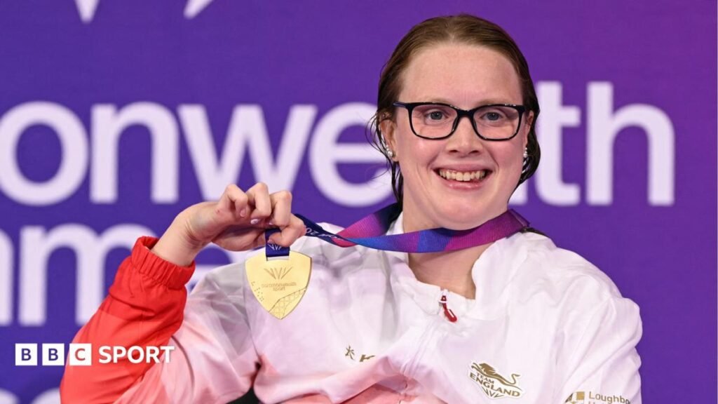 Brock Whiston holds up her Commonwealth Games gold medal