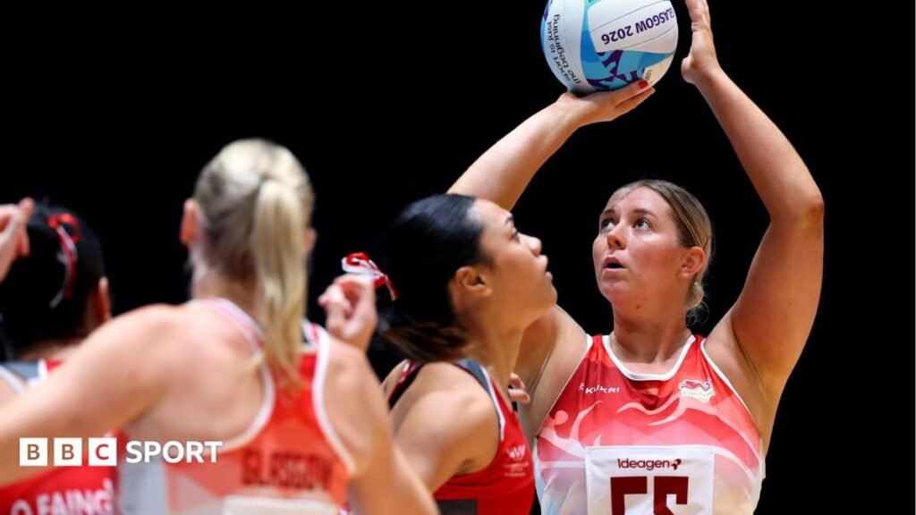 Commonwealth Games 2026: England netball team thrash Tonga to boost semi-final hopes Eleanor Cardwell, wearing England's red and white netball vest top, shooting a goal in the win over Tonga at the Commonwealth Games