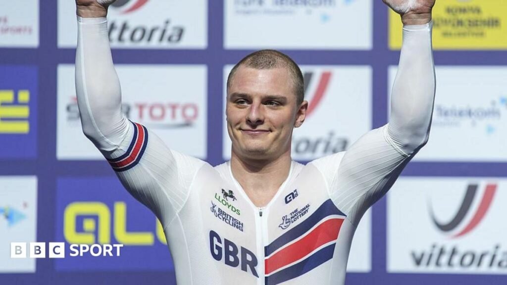 Commonwealth Games 2026: Matt Richardson ready to face ex-Australian team-mates Matt Richardson in white British kit with GBR lettering raises arms aloft in front of sponsor background