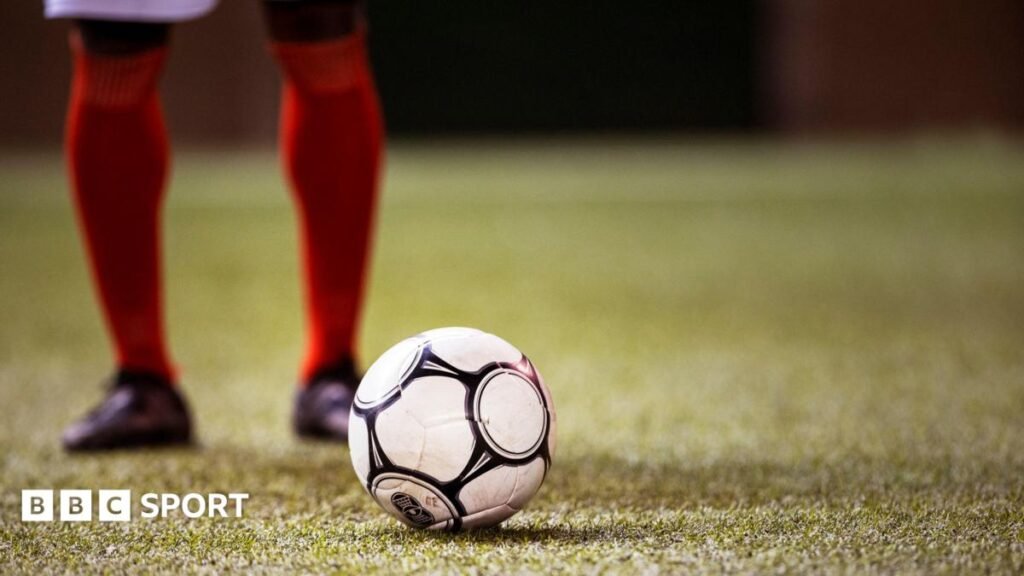 Football brain health: Players more likely to suffer from depression and anxiety, study says A football player stands behind a ball