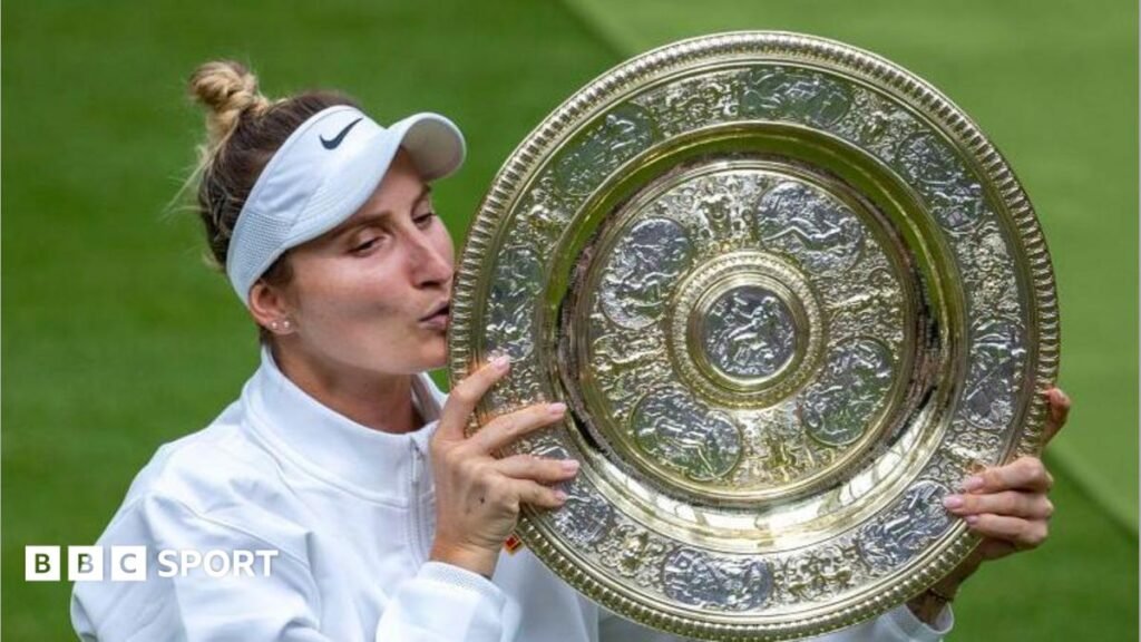 Marketa Vondrousova kisses the Venus Rosewater Dish at Wimbledon in 2023