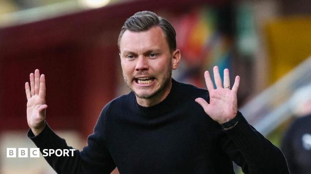 Motherwell boss Alfred Johansson raises his hands