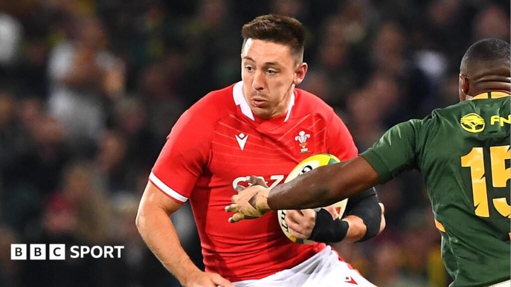 Josh Adams runs with the ball under his left arm for Wales in South Africa
