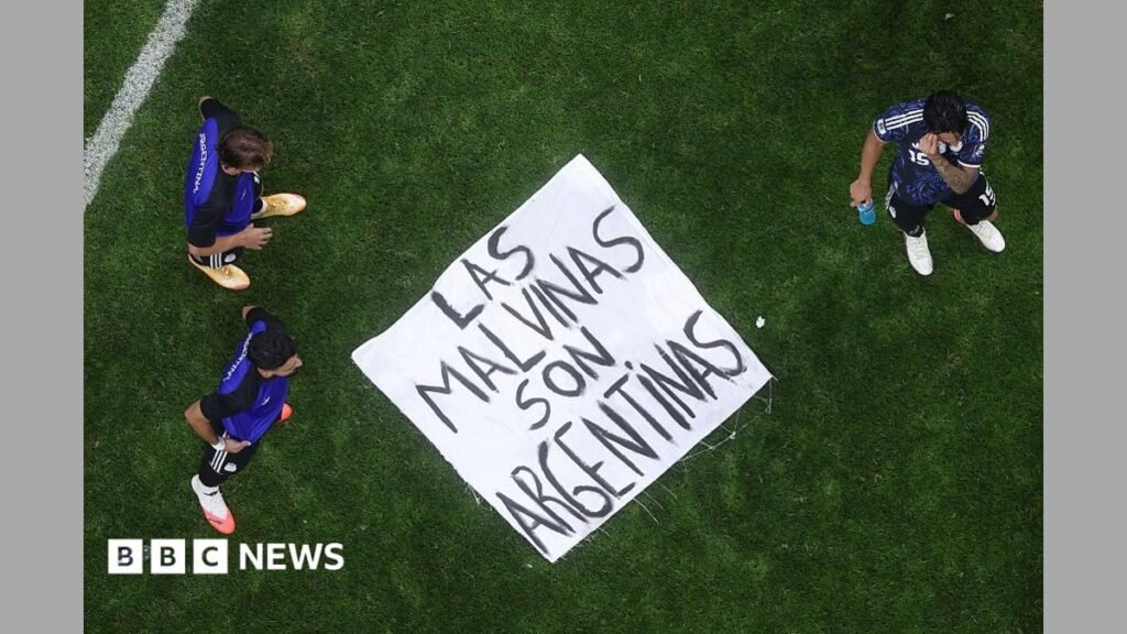 White House defends Argentina team over Falklands banner A banner saying "Las Malvinas Son Argentinas" is on the ground of a pitch with three players standing around it