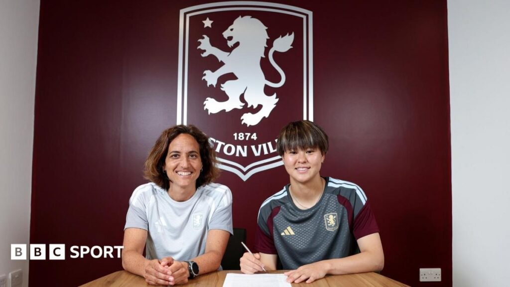 Women’s Super League transfer news: Aston Villa sign Japan goalkeeper Akane Okuma Akane Okuma signs contract in front of large Aston Villa emblem