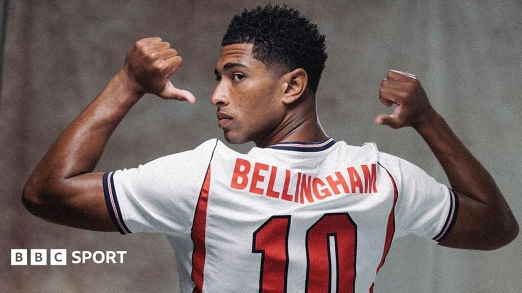 World Cup 2026: England’s Jude Bellingham return to indispensability A picture of Jude Bellingham in a publicity shot wearing an England shirt, staring at the camera.