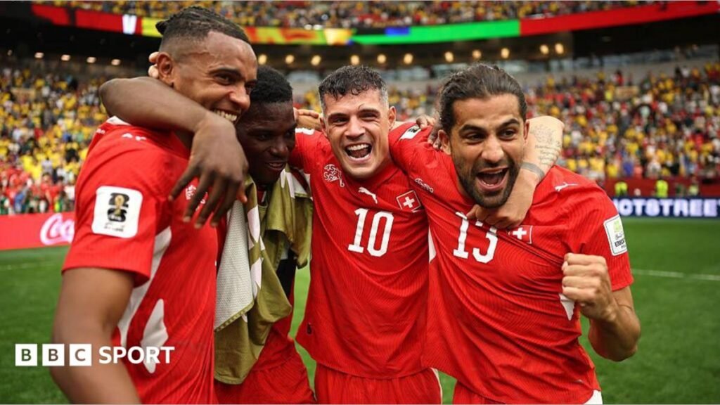 Switzerland players celebrate beating Colombia