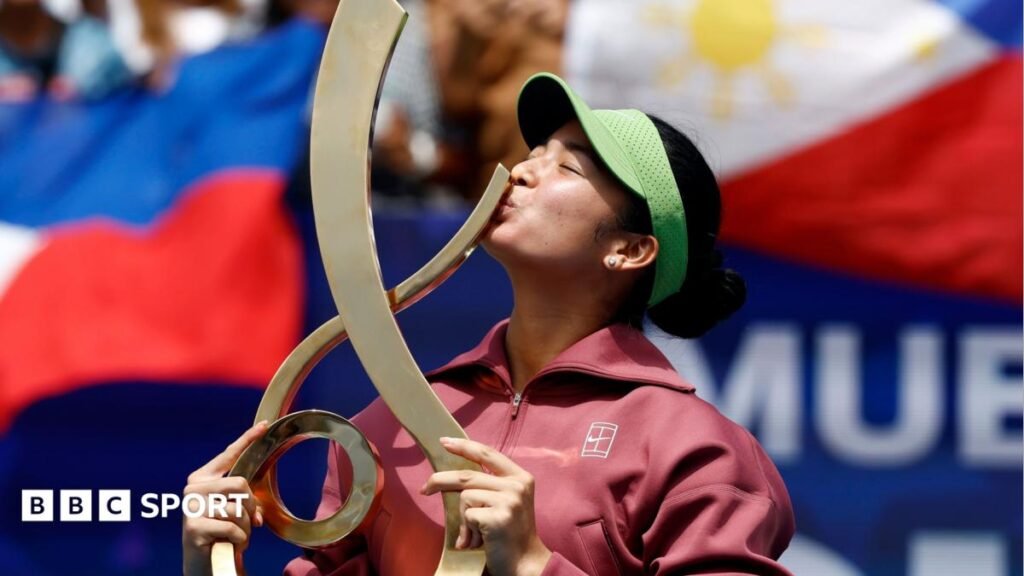 Alexandra Eala kisses the trophy