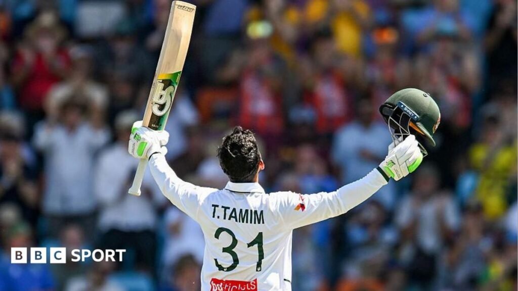 Tanzid Hasan Tamim raising his bat and looking to the sky after reaching his century.