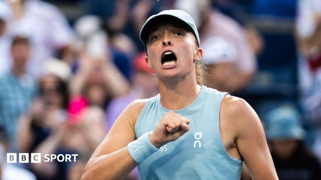 Iga Swiatek punches her chest in celebration