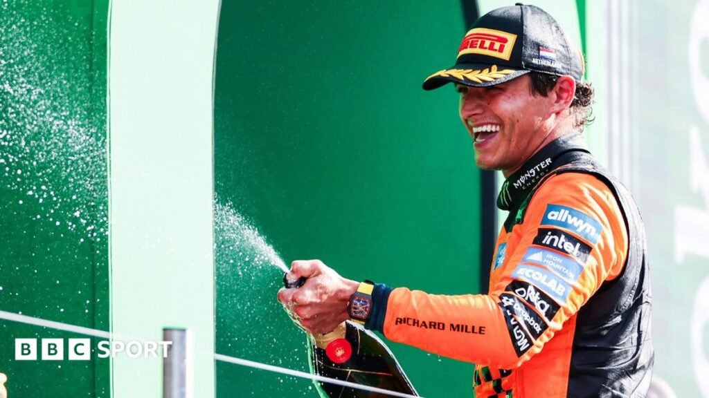 Lando Norris sprays champagne on the podium after his win at the 2026 Dutch Grand Prix