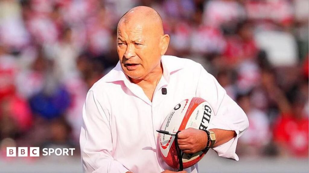Japan coach Eddie Jones holding a rugby ball