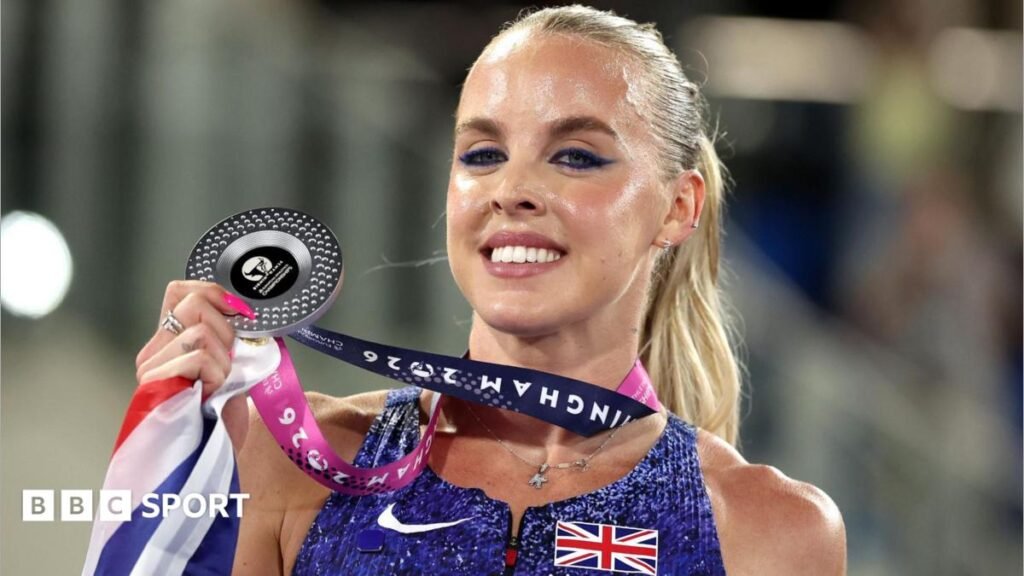 Audrey Werro celebrates gold with the Swiss flag behind her