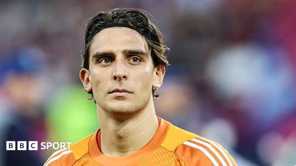 Head and shoulders of Konstantinos Tzolakis, wearing an orange goalkeeper shirt