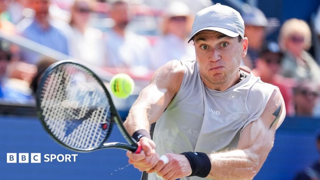 Jack Draper strikes the ball with his racquet