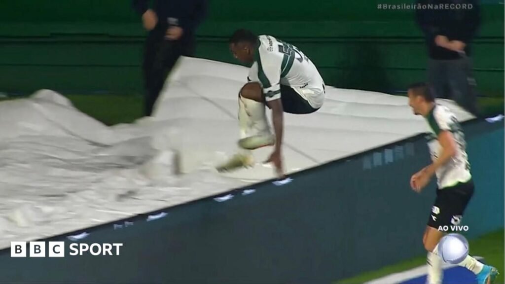 Jacy got ‘carried away’ as goal celebration goes wrong Image of Jacy Maranhao falling down a hole after jumping over the advertising boards