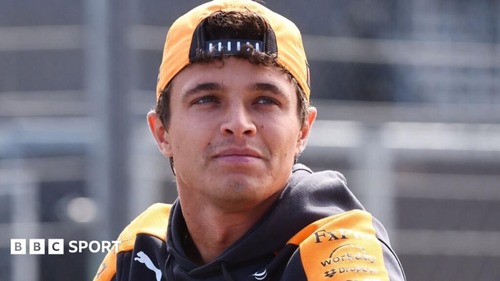 Lando Norris, in McLaren kit, pictured wearing a cap turned around backwards before the 2026 Dutch Grand Prix