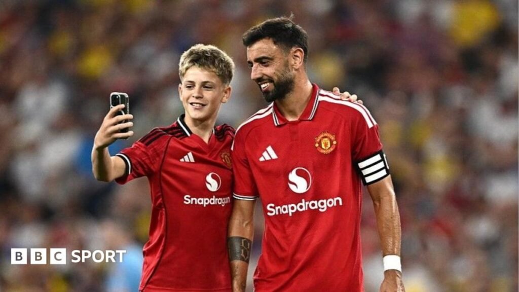 Manchester United skipper Bruno Fernandes poses for a selfie with a young fan during the pre-season game with Leeds at Croke Park
