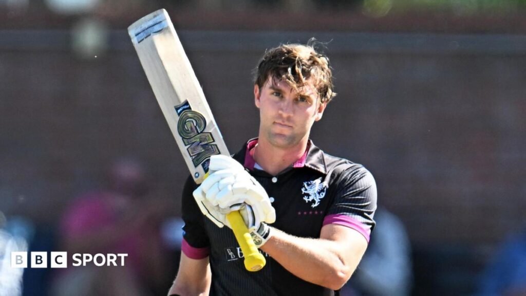 Somerset batter Tom Lammonby raises his bat after scoring a century in the Metro Bank One Day Cup win over Surrey at Taunton