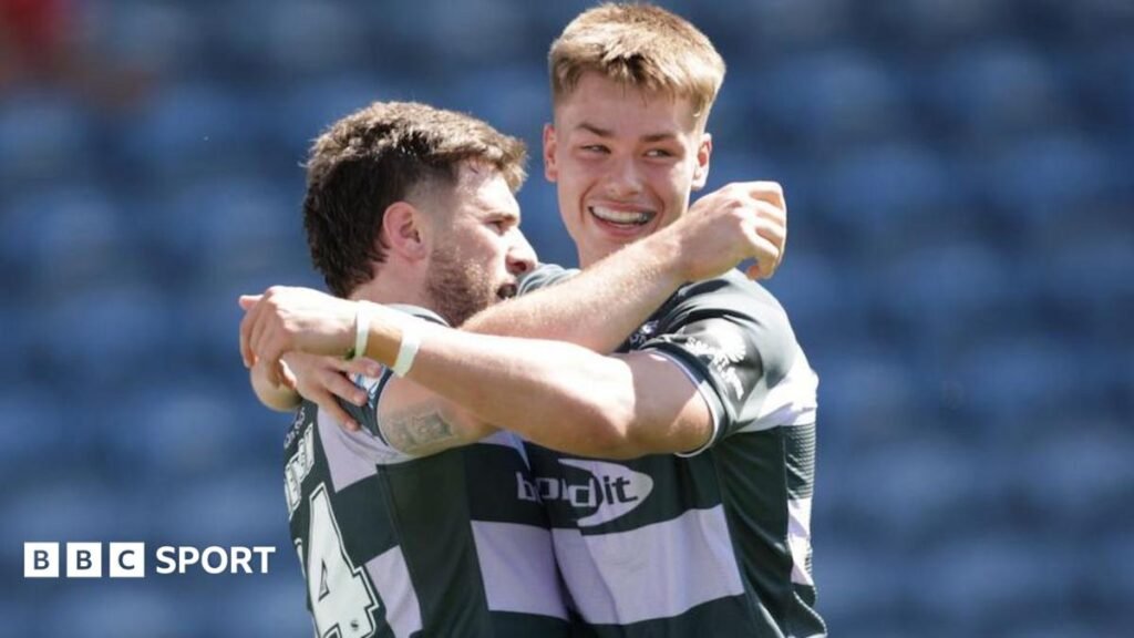 Fenton Rogers (left) holds out his arms to celebrate scoring Huddersfield Giants' second try in their win over Catalans Dragons