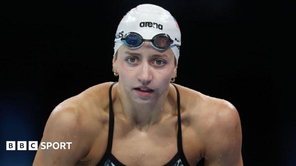 Head, shoulders and upper body  view of Kate Douglass, who is in swimsuit, goggles and white swimming cap during a training session at the Paris 2024 Olympics